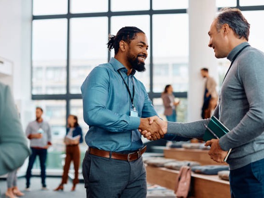 Partnership handshake at a business event
