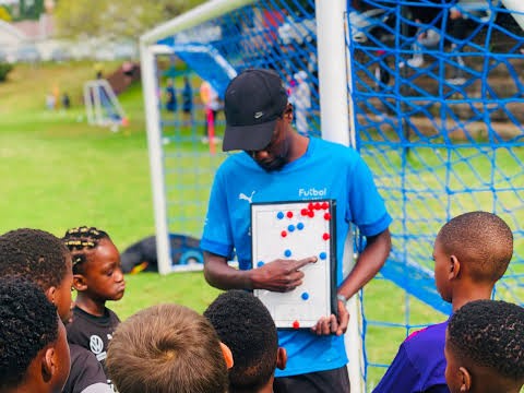 Youth coach reviewing tactics with young players