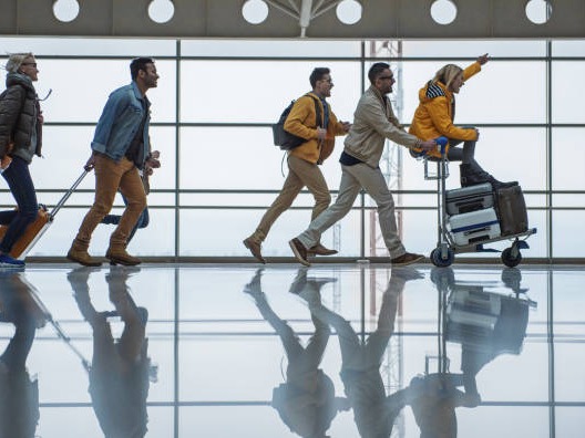 Team traveling through an airport terminal